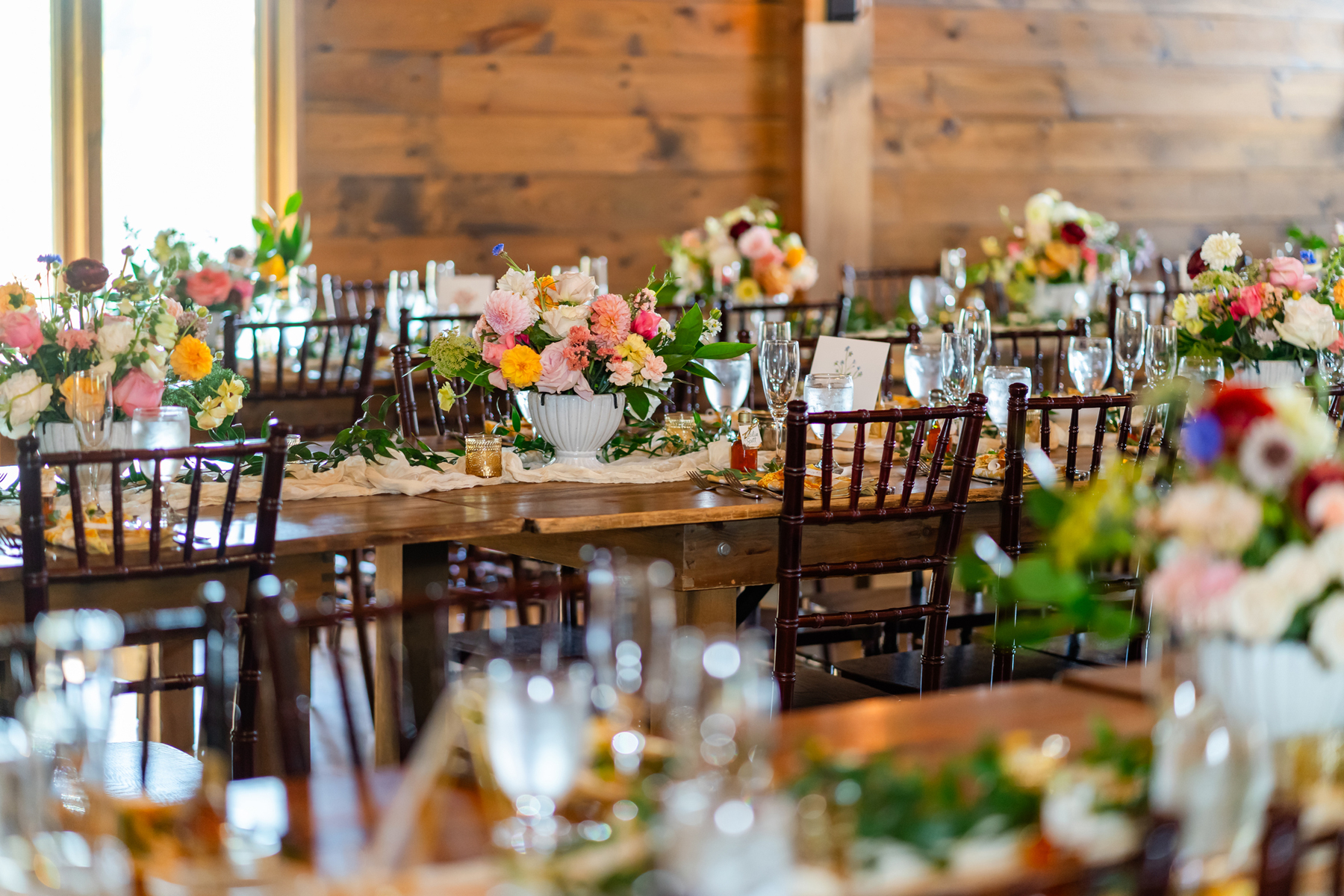 Lake view Fall wedding by a Burlington Vermont wedding florist golden mustard yellow and pink wedding flowers for a lakeside wedding in southern Vermont wedding venue Lake Bomoseen Lodge Castelton Vermont bride and groom first look with golden mustard wedding farmhouse table centerpieces