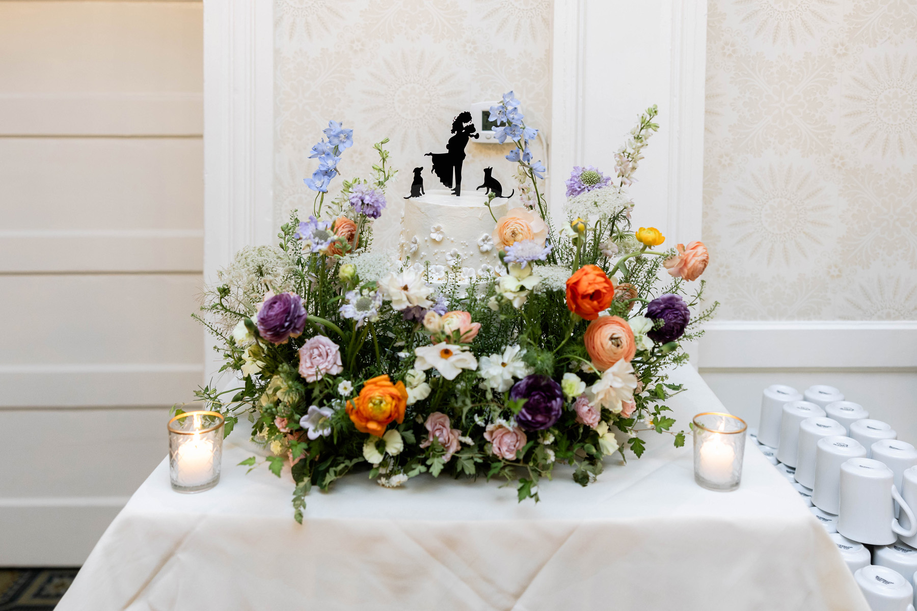 Burlington Vermont Wedding florist created a wedding cake garden meadow of flowers surrounding the wedding cake.
